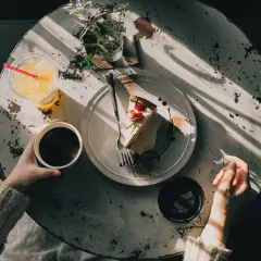 Kawa z ciastkiem i napojem. Czy w kawie ince jest kofeina? Pytanie wisi w powietrzu, gdy słońce rzuca cienie na stół.