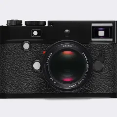 A classic black Leica 240 camera with a Summilux-M 50mm f/1.4 ASPH lens. This iconic camera is ready to capture timeless moments.