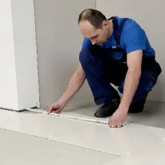 Fachowiec układa płytki 60x60, dbając o równe fugi. Wzory układania płytek są kluczowe dla estetyki.