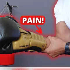 A boxer's forearm is being gripped, with a "PAIN!" graphic and arrow pointing to the wrist. Do strong forearms help you punch harder?