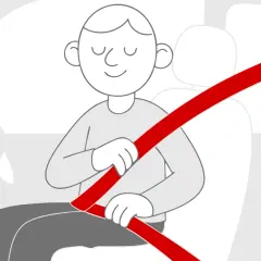 Uśmiechnięty kierowca zapina pasy, unikając mandatu za brak zapiętych pasów. Bezpieczeństwo przede wszystkim!