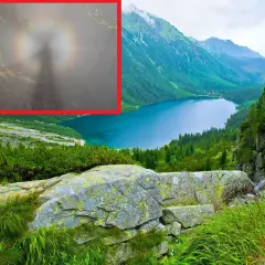 Widok na jezioro w górach, a w powiększeniu tajemnicza sylwetka otoczona tęczową aureolą – to efekt brockenu.