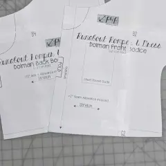 Close-up of a DIY romper pattern for a "Runabout Romper & Dress," showing front and back bodice pieces with instructions like "Cut 1 on Fold" and "Stretch.