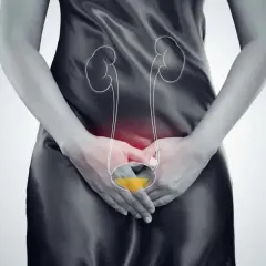 Kobieta z bólem w podbrzuszu, symbolizującym zapalenie dróg moczowych. Czerwony obszar wskazuje na stan zapalny.