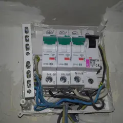 Widok z bliska na skrzynkę z bezpiecznikami i przewodami elektrycznymi.