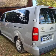 Srebrna Toyota z tablicą ZK 9627K, idealna na cesja leasingu. Zaparkowana przy drewnianym domu z krytym strzechą dachem.