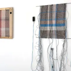 Deux œuvres d'art de tissage dessin, ornées de fils et de câbles, sont accrochées à un mur blanc.