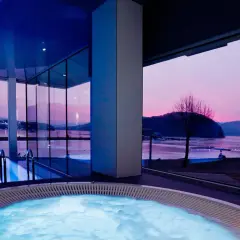 Relaks w jacuzzi z widokiem na zachód słońca. Idealne **tanie spa dla dwojga** w nowoczesnym stylu.
