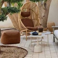 Gemütliche kleine Terrasse gestalten: Rattan-Sessel, Hocker, Sofa und Beistelltische laden zum Entspannen ein.