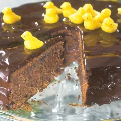 En saftig chokladtårta med blank glasyr, dekorerad med små gula kycklingar. En perfekt påsktårta för alla chokladälskare!