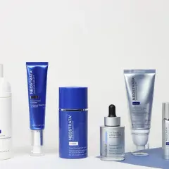 A collection of Neostrata skincare products, including serums, creams, and a wash, arranged on a white surface.
