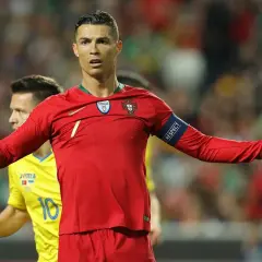 Cristiano Ronaldo w czerwonej koszulce Portugalii, z opaską "RESPECT", na tle drabinki rozgrywek Mistrzostw Europy w piłce nożnej.