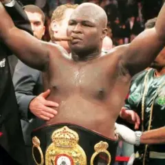 Boxer James Toney, with a cigar in his mouth and championship belt, celebrates a victory. His impressive **James Toney record** speaks for itself.