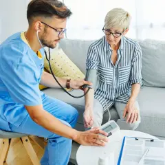 Un infirmier mesure la tension d'une patiente. Un remède de grand-mère pour tension basse pourrait être utile.