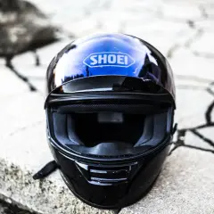 Casco Shoei negro y azul, listo para aprender como limpiar casco de moto y mantenerlo impecable.