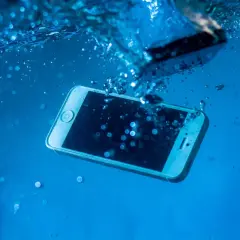 Telefon zanurzony w wodzie. Zastanawiasz się, jak wysuszyć port USB? Szybko wyjmij go z wody i osusz.