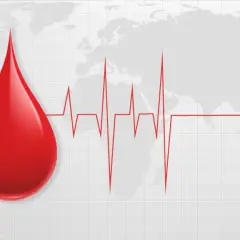 Kropla krwi na tle mapy świata i wykresu EKG. Symbolizuje życie i zdrowie, a także podkreśla, jak cenna jest najrzadsza grupa krwi.