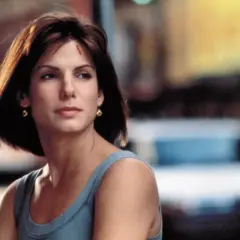 Sandra Bullock w niebieskiej sukience, zastanawia się, ile ma lat.