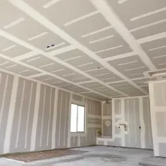 Interno di un locale in costruzione con pareti e soffitto in cartongesso, in attesa del passaggio degli impianti.