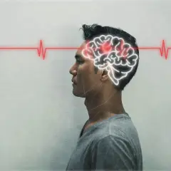 Mężczyzna z konturem mózgu i czerwoną linią EKG, symbolizującą jego stan.
