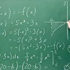 Rysunek na tablicy pokazuje obliczenia matematyczne, w tym całki i funkcje, ilustrujące, co to system zero jedynkowy a binarny.