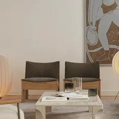 Un salón moderno con dos lámparas de pie grandes, una rosa y otra blanca, iluminando el espacio.