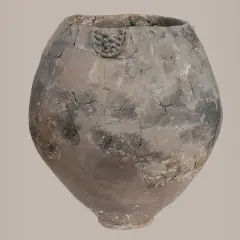 Vase antique craquelé, témoin du berceau du vin. Son argile patinée raconte des histoires de fermentation et de partage.