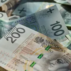 Złote banknoty 100 i 200 zł, symbolizujące średnią pensję w Polsce.