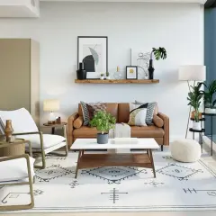A modern traditional interior design featuring a brown leather sofa, white armchairs, and a geometric rug.