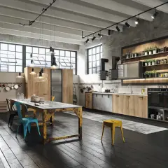 Nowoczesna kuchnia w stylu loft z drewnianymi frontami, betonową ścianą i industrialnymi lampami. Idealne miejsce na wspólne gotowanie.