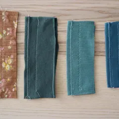 Four fabric swatches, including a floral print and solid colors, show different cut and sew knits techniques with visible white stitching.