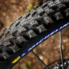 Close-up of a rugged Michelin Force AM2 tire, ready to grip the trail.
