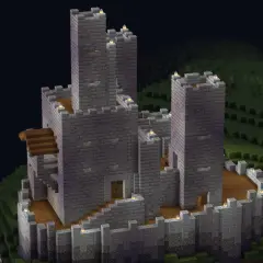Potężny kamienny zamek z wieżami, dziedzińcem i schodami. To pokazuje, co można zbudować w Minecraft.