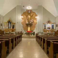 Wnętrze kościoła z ławkami i ołtarzem. Niech będzie pochwalony Jezus Chrystus.
