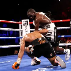 Terence Crawford, a southpaw, lands a powerful punch, sending his opponent to the canvas.