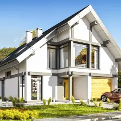 Nowoczesny dom 70m2 z poddaszem, z dużymi oknami i garażem. Otoczony zielenią i jesiennymi drzewami.