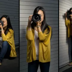 A woman demonstrates how to hold a camera in three poses: sitting, standing, and leaning against a wall.