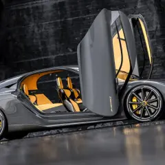 Szary Koenigsegg Gemera z otwartymi drzwiami i żółtym wnętrzem. Poznaj Koenigsegg Gemera cena i możliwości tego cudu techniki.