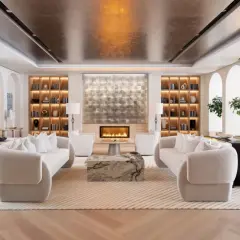 A luxurious living room designed by top interior designers, featuring plush sofas, a modern fireplace, and elegant built-in shelving.