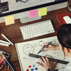 A graphic designer sketches logo ideas, a key step in learning how to make money as a graphic designer.
