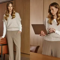 Elegancki damski dress code biznesowy: beżowy sweter bez rękawów na białej bluzce, brązowe spodnie. Kobieta z laptopem.