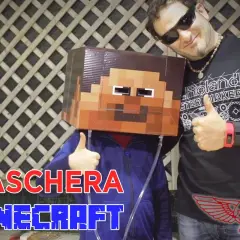 Un bambino indossa una maschera fai da te di Minecraft. Un uomo sorride e fa il pollice in su.