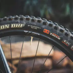 Close-up of a Maxxis Minion DHF tire, 27.5x2.50WT, 50 PSI, EXO Protection, TR. Ready for any trail, unlike the DHR.