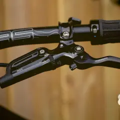 Close-up of a black SRAM Guide RSC brakes lever on a bicycle handlebar.