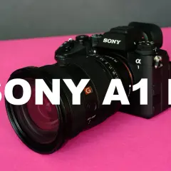 Profesjonalny aparat Sony A1 II z obiektywem na różowym tle.