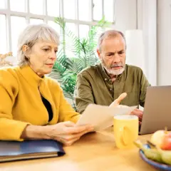 Couple âgé examinant un relevé de carrière, peut-être pour une lettre de demande de régularisation.