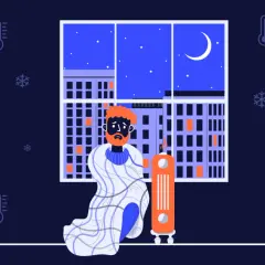 En man med orange hår och skägg sitter insvept i en filt bredvid en element. Utanför fönstret syns en stad i mörker med snöflingor och termometrar som visar att det är kallt i huset.