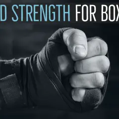 Close-up of a boxer's fist wrapped in tape, with text "HAND STRENGTH FOR BOXING" above. Learn how to strengthen wrists for boxing.