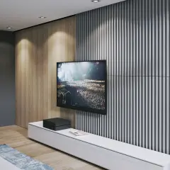 Nowoczesna ściana TV: beton i lamele tworzą stylowe tło dla ekranu. Drewniane panele dodają ciepła.