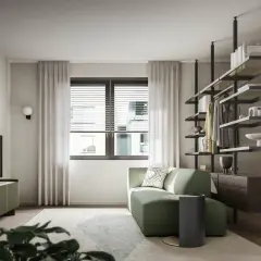 Divano verde smeraldo in un soggiorno moderno. Il verde sta bene con il legno scuro e i toni neutri, creando un'atmosfera rilassante.